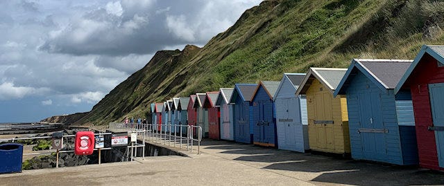 a row of colourful beach huts 