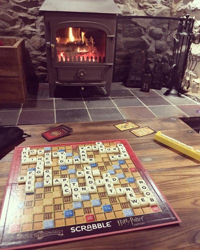 A lit log burner and a game of Scrabble in the evening
